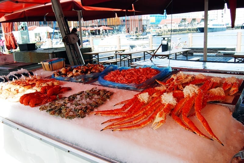 Fisketorget in Bergen, [Fish Market], is a square at the head of the harbor in Bergen where there is a marketplace of stalls for the sale of fish , shellfish , berries , fruits and flowers